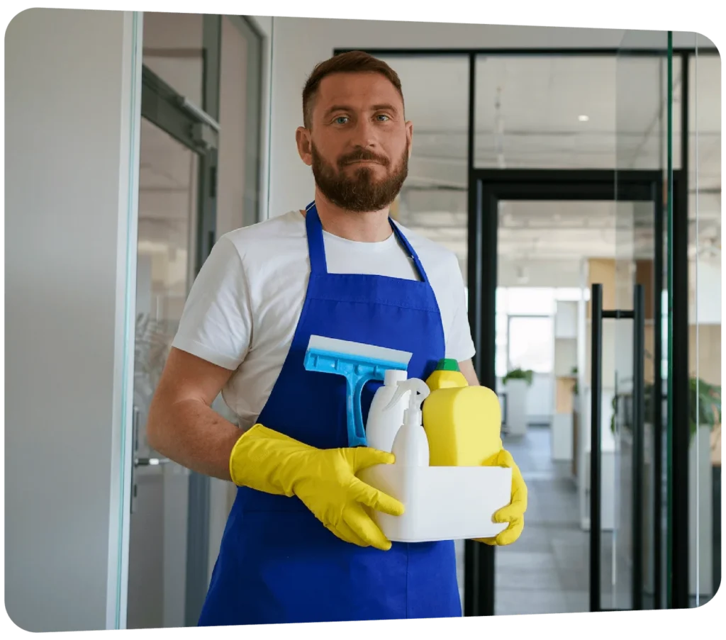 Male janitorial staff holding commercial cleaning supplies