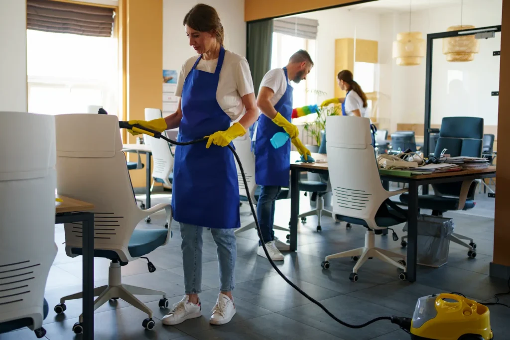 Cleaning team performing post-construction cleanup in a newly finished office environment.